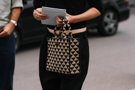Milan, Italy - September 21, 2023: fashioner wearing Prada Symbole shoulder bag. Fashion blogger...