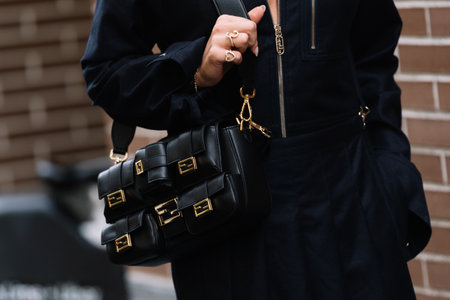 Milan, Italy - September 20, 2023: fashioner wearing Fendi Multipocket Baguette bag. Fashion blogger outfit details, street styleのeditorial素材