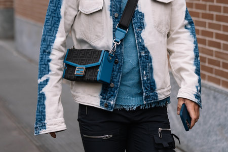 Milan, Italy - February 22, 2023: man wearing Fendi shoulder bag. Fashion blogger outfit details, street styleのeditorial素材