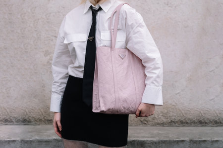 Milan, Italy - February 23, 2023: woman wearing Prada nappa Antique shoulder bag. Fashion blogger outfit details, street styleのeditorial素材