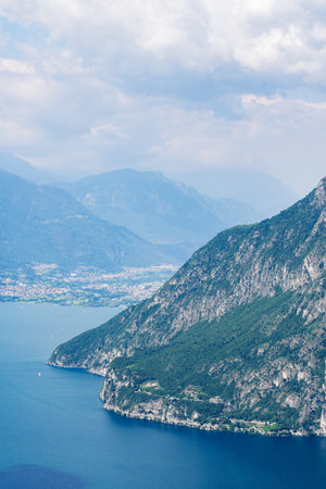 Mountain landscape, picturesque mountain lake in the summer morning, large panorama, landscape with fabulous lake view from the top of the mountain, with view of the city. Iseo, Italyの写真素材