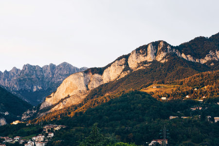 Beautiful landscape of the layered misty hazy Italian Alps mountain range during evening. Alpine...