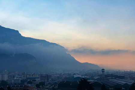Beautiful landscape of the layered misty hazy mountain range during evening. Alpine summer sunrise....