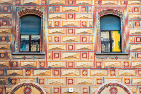 intricate geometric patterns and colorful designs on building facade with arched windows