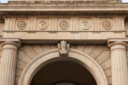 close up of ornate stone archway with columns, detailed carvings, and face sculptureの写真素材