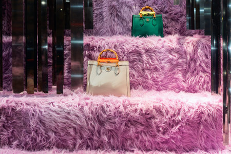 Florence, Italy - 31.08.2022: window display of Gucci store in Milan, bags on vitrine of the shop.