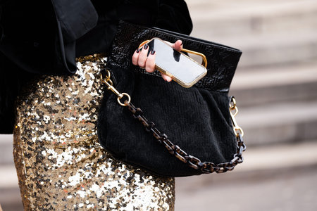 Milan, Italy - February, 25, 2024: woman wears Louis Vuitton bag, fashion blogger outfit details,...