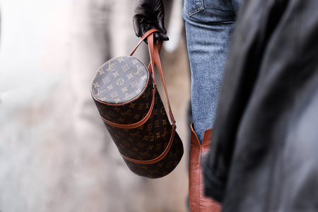 Milan, Italy - February, 25, 2024: woman wears Louis Vuitton bag, fashion blogger outfit details,...