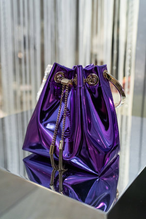 Milan, Italy - February, 25, 2023: Jimmy Choo bag on podium showcase, woman accessories in the store.のeditorial素材
