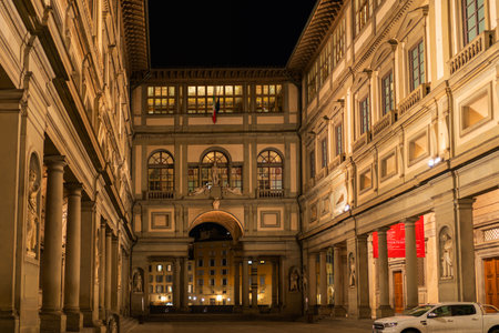 Florence, Italy - August, 31, 2022: imposing architectural facade of a historical building, beautifully lit at night, showcasing classical design and statuesのeditorial素材