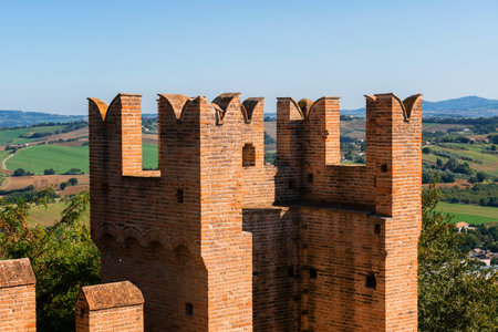 Gradara, Italy - August, 25, 2022: close up of battlements of Gradara Castle with green fields in the background, Italyのeditorial素材