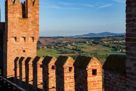 Gradara, Italy - August, 25, 2022: castle wall with battlements and scenic countryside view in...