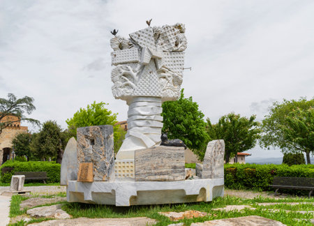 Gradara, Italy - August, 25, 2022: abstract stone sculpture displayed in a green outdoor park, blending art with natureのeditorial素材