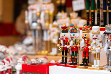 Vibrant collection of nutcrackers in various designs and colors on display at a Christmas market stall. Joyful holiday atmosphereの写真素材
