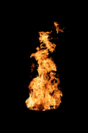 Fire flame burning isolated on dark background. Abstract fireplace burning light on black backdrop....