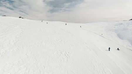 Livigno, Italy - February 21, 2022: People snowboarding skiing at ski resort. Skiers, snowboarders...
