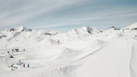 People snowboarding skiing at ski resort. Skiers, snowboarders riding snowy mountain slope. Outdoor winter sport and scineric panoramic view.の写真素材