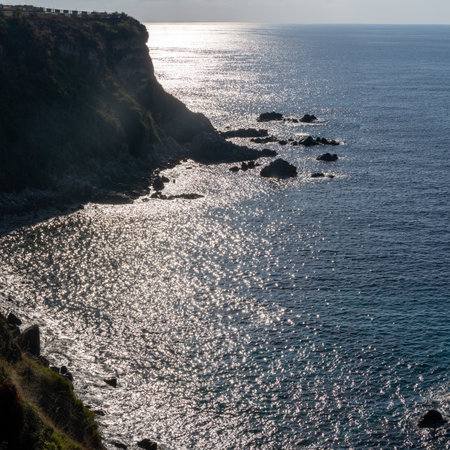 View of coastline in southern Italy. Scenic view from on top cliff looking out to sea on sunny summer day. Calabria coastline with eroded cliff on beachの写真素材
