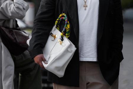 Paris, France - October, 4, 2025: man wears white Hermes Birkin leather shoulder bag, modern fashion accessories, street style handbagのeditorial素材