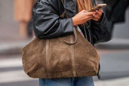Paris, France - October, 6, 2025: Woman wears Sezane black shoulder bag. Fashion outfit handbag detail, street style look accessoryのeditorial素材