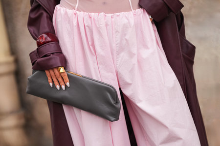 Paris, France - October, 6, 2025: Woman wears gray Mango clutch bag. Fashion outfit handbag detail, street style look accessoryのeditorial素材