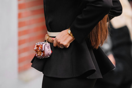 Milan, Italy - September, 24, 2025: woman wears Fendi nano baguette charm bag. Fashion outfit handbag details, street style look accessoryのeditorial素材
