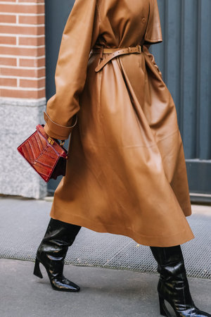 Milan, Italy - September, 24, 2025: woman wears white Fendi ISeeU Petite brown bag. Fashion outfit handbag details, street style look accessoryのeditorial素材