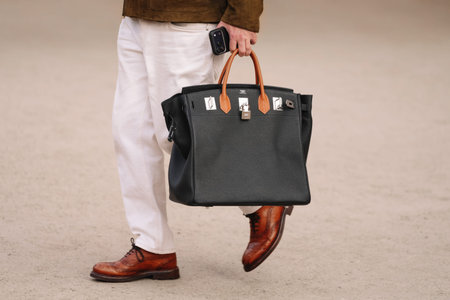 Paris, France - January, 26, 2026: woman wears Hermes bag. Fashion outfit handbag details, street style look accessory