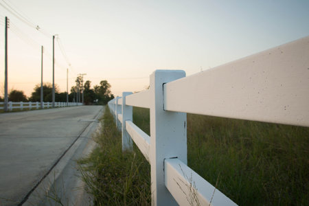 white fench near the roadの写真素材