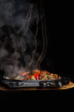 Flamed hot bbq on plate on dark backgroundの写真素材