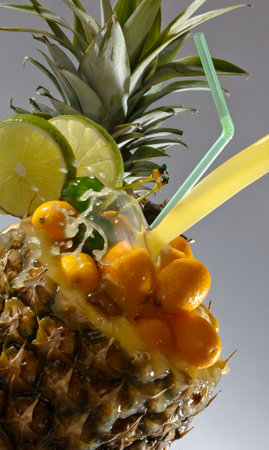 Colourfull cocktail with tropical fruit in pineapple
