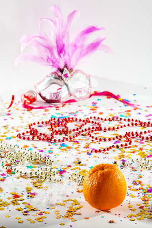 Christmas theme with orange and mask on a white backgroundの写真素材