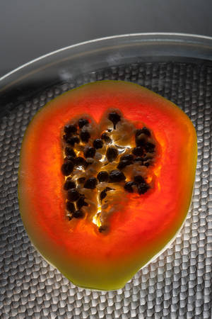 tasty cut papaya closeup on a plateの写真素材