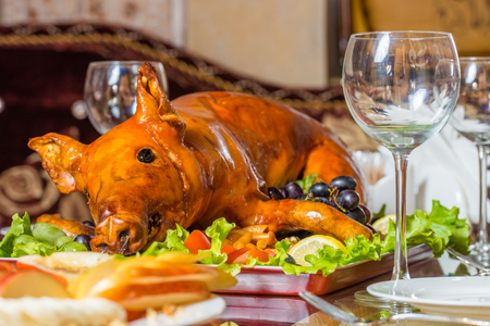 Roasted pig on rich table in eastern restaurantの写真素材