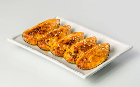 Fried zucchini slices on a white backgroundの写真素材