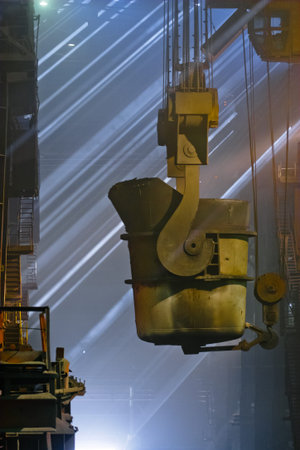 Workers cater for equipment in the steel producing workshop