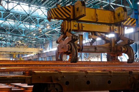 Process of manufacturing metal. Crane carries metal at the plantの写真素材
