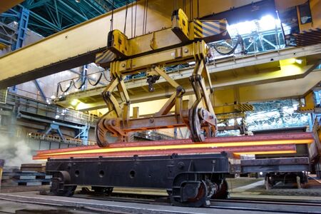 Process of manufacturing metal. Crane carries metal at the plantの写真素材