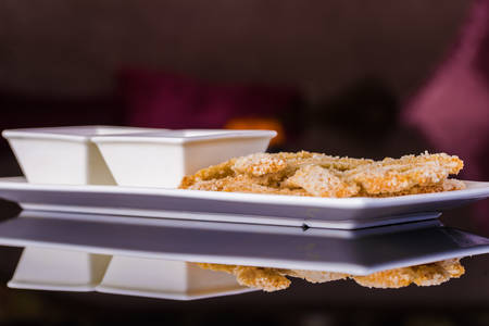 Breaded fish fillets with sauces on the tableの写真素材