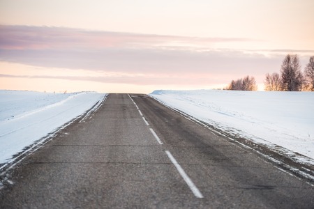 winter road with a view of the sky and sunsetの写真素材