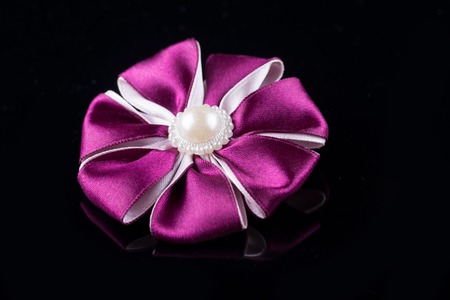 Purple flower hair band handmade decoration on black backgroundの写真素材
