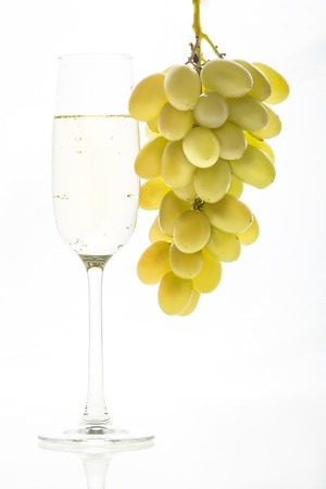 Glass of champagne and grapes. Christmas backgroundの写真素材