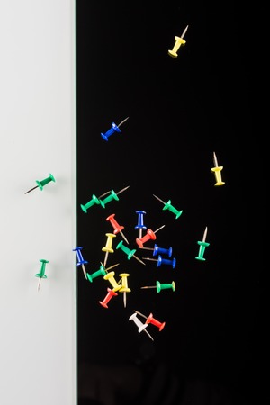 set of color push pins on white and black backgroundの写真素材