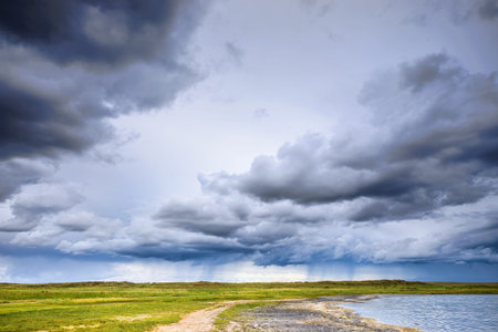 Beautiful natural lake landscape against the cloudy skyの写真素材