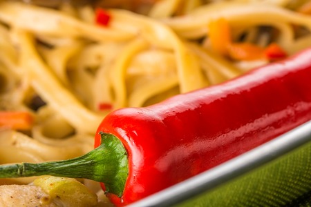 Asian noodles with mushrooms, herbs and red hot chili pepperの写真素材