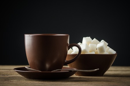 coffee cups, beans and sugar on rustic wooden table backgroundの写真素材