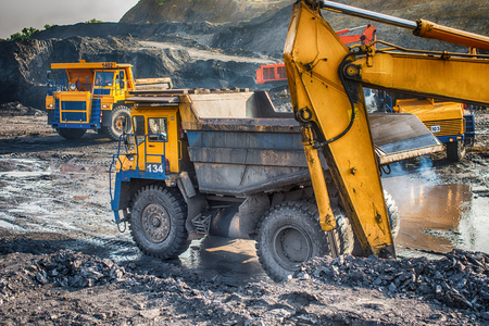 Big yellow mining trucks and excavatorsのeditorial素材