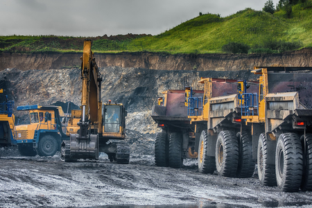 Big yellow mining trucks and excavatorsのeditorial素材