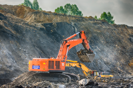 NOVOKUZNETSK, RUSSIA - JULY 26, 2016 Big orange and yellow excavators at worksiteのeditorial素材