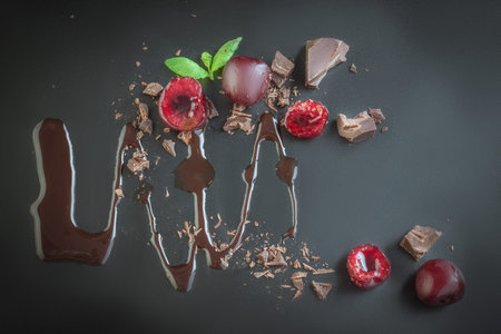 pieces of milk chocolate and cherriesの写真素材